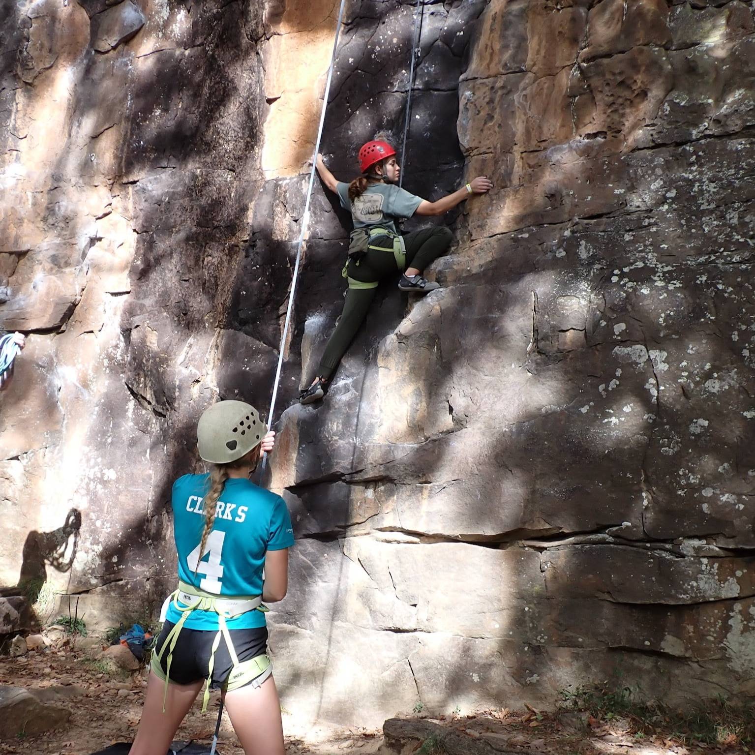 student rock climbing