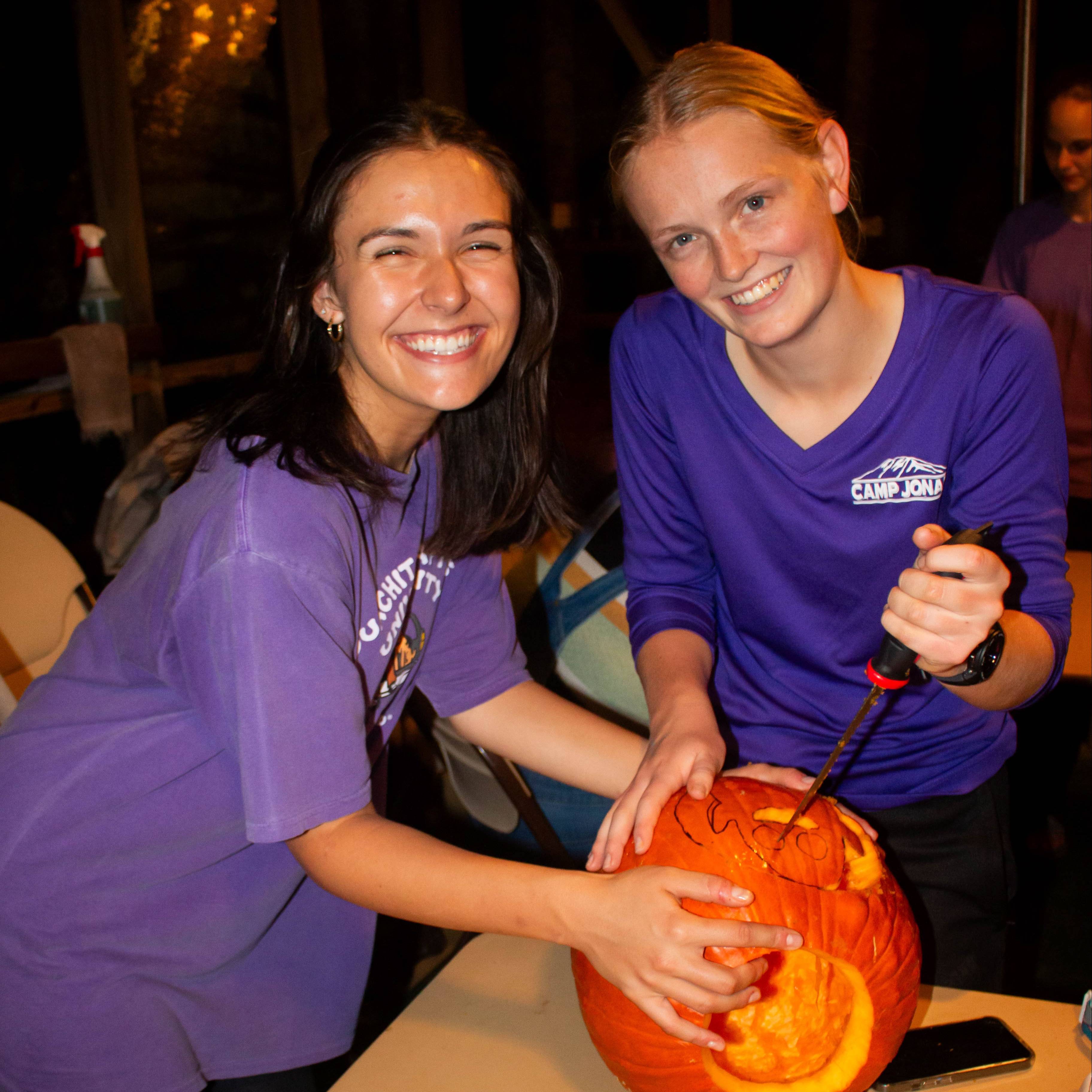 students carving pumpkin