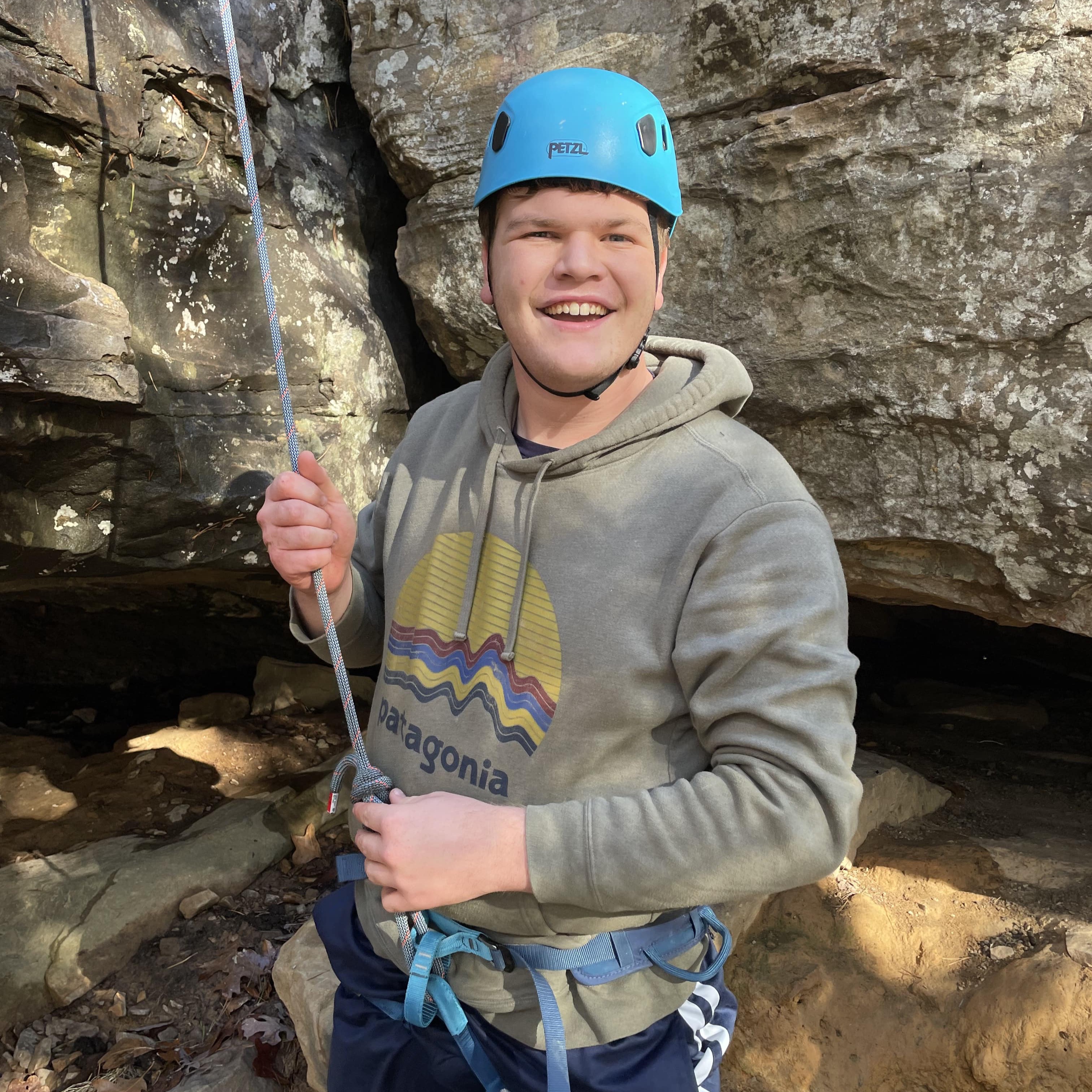 student rock climbing