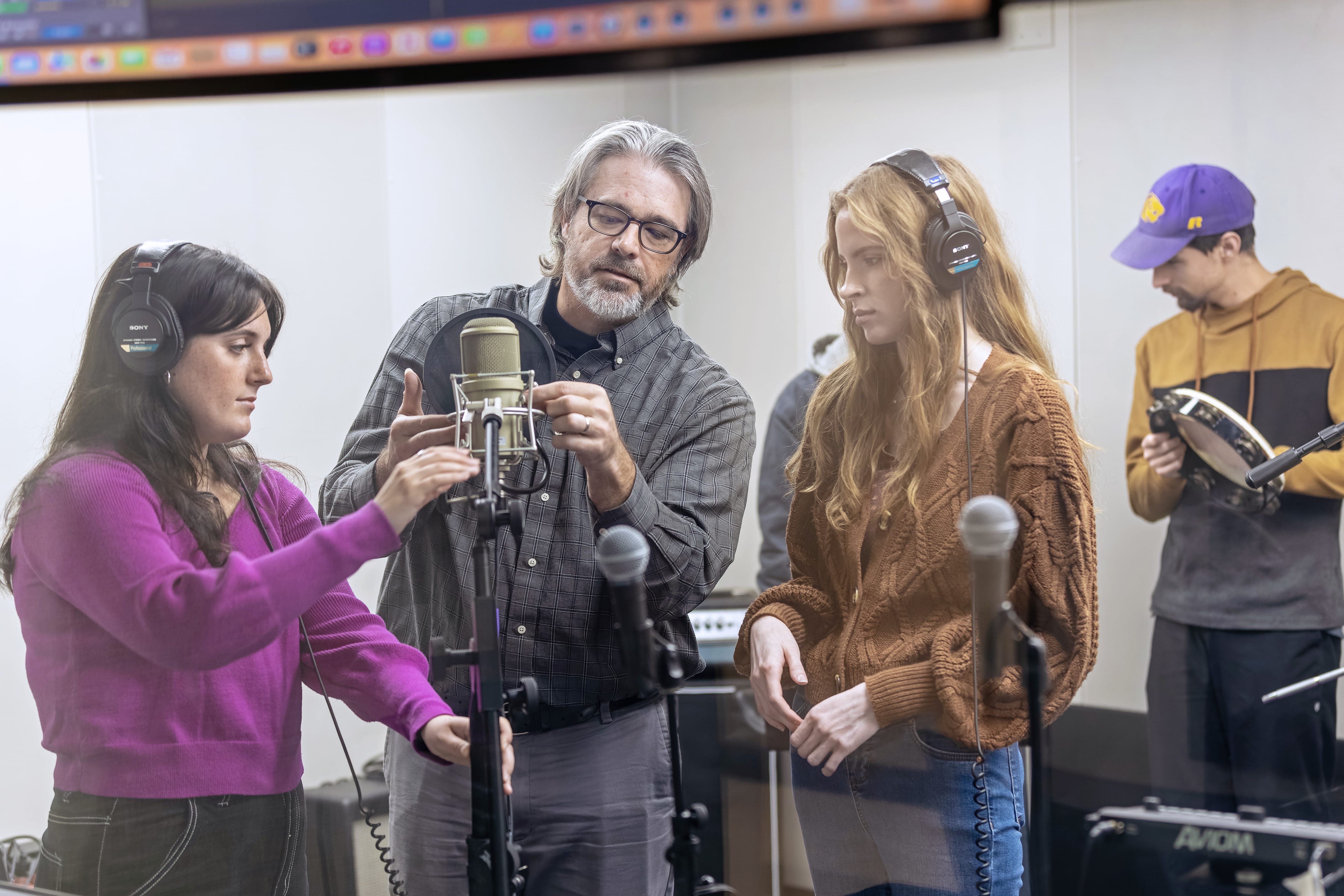 Professor with students in studio